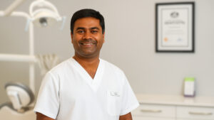 Dr. Vas experienced orthodontist smiling at dental clinic on Sunshine Coast