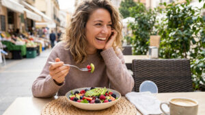 Woman enjoying a meal after removing Spark Aligners, highlighting the convenience of removable clear aligners.