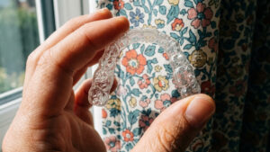 Close-up of a Spark clear aligner demonstrating its crystal-clear material and comfortable fit.